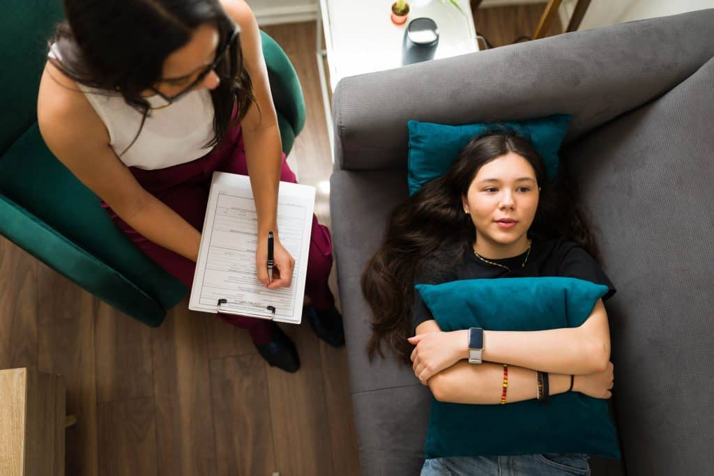 Teenage girl laying on couch