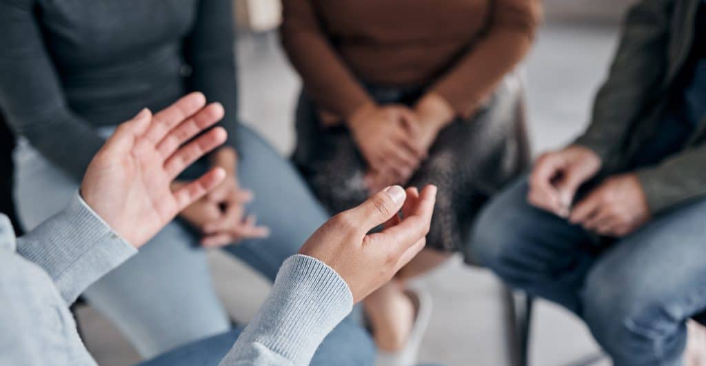 closeup of hands at support group