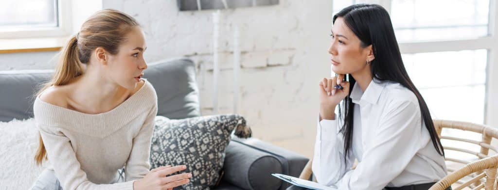 two woman talking in therapy