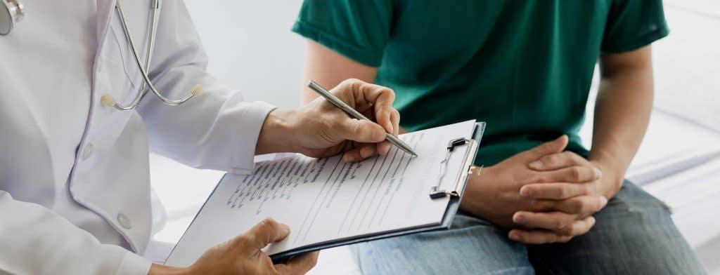 Person writing on a clipboard