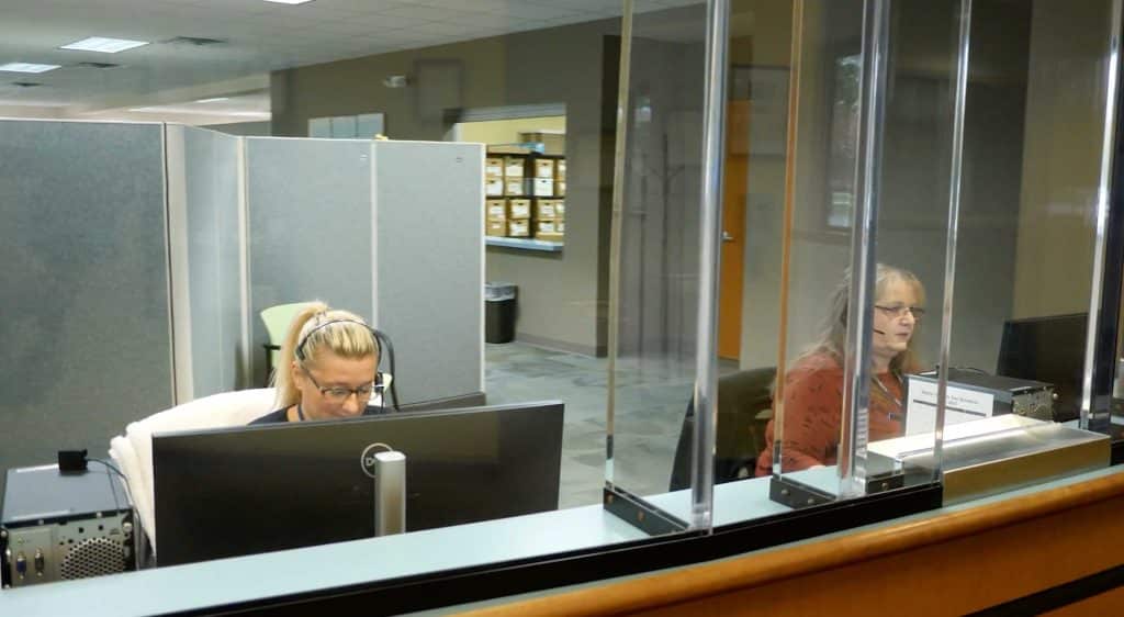 people working at the front desk of an office