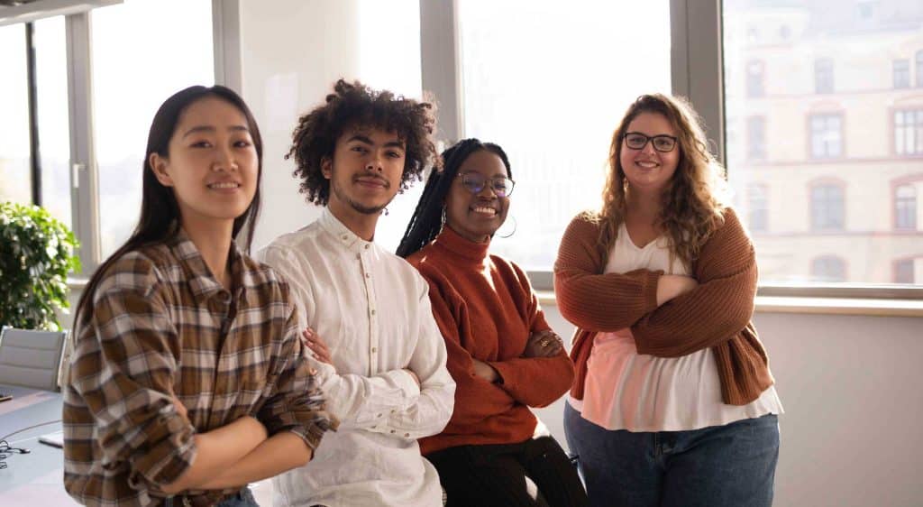 diverse people looking at the camera smiling